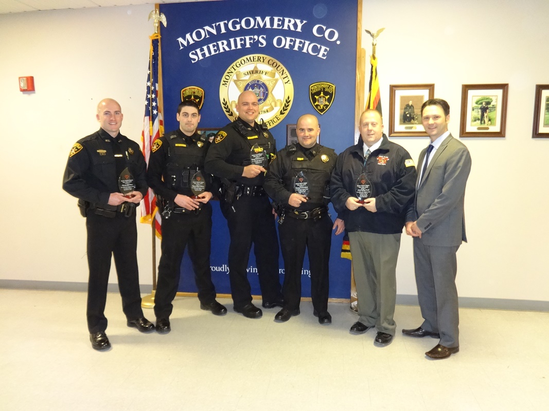 Deputies being honored and holding the plaques they received