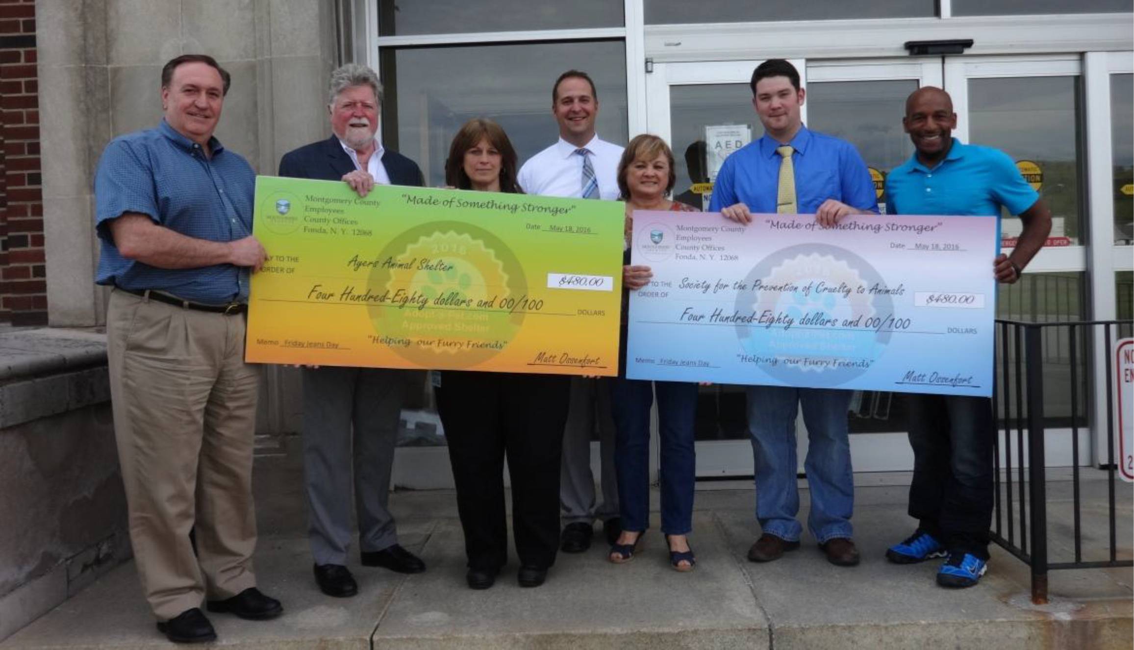 County officials present the Ayers Animal Shelter and the Montgomery County SPCA with checks for money raised by county employees during 'Jeans Days'