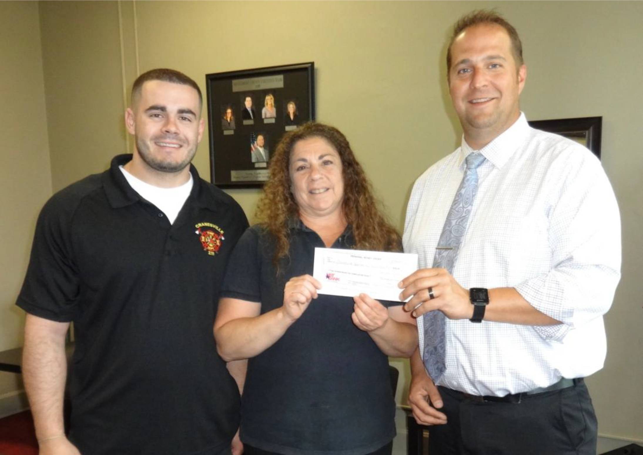 County Executive Matthew L. Ossenfort (right) presents a check to Cranesville Volunteer Fire Department's Joseph Sawyer and President/Firefighter Marilyn Sawyer.