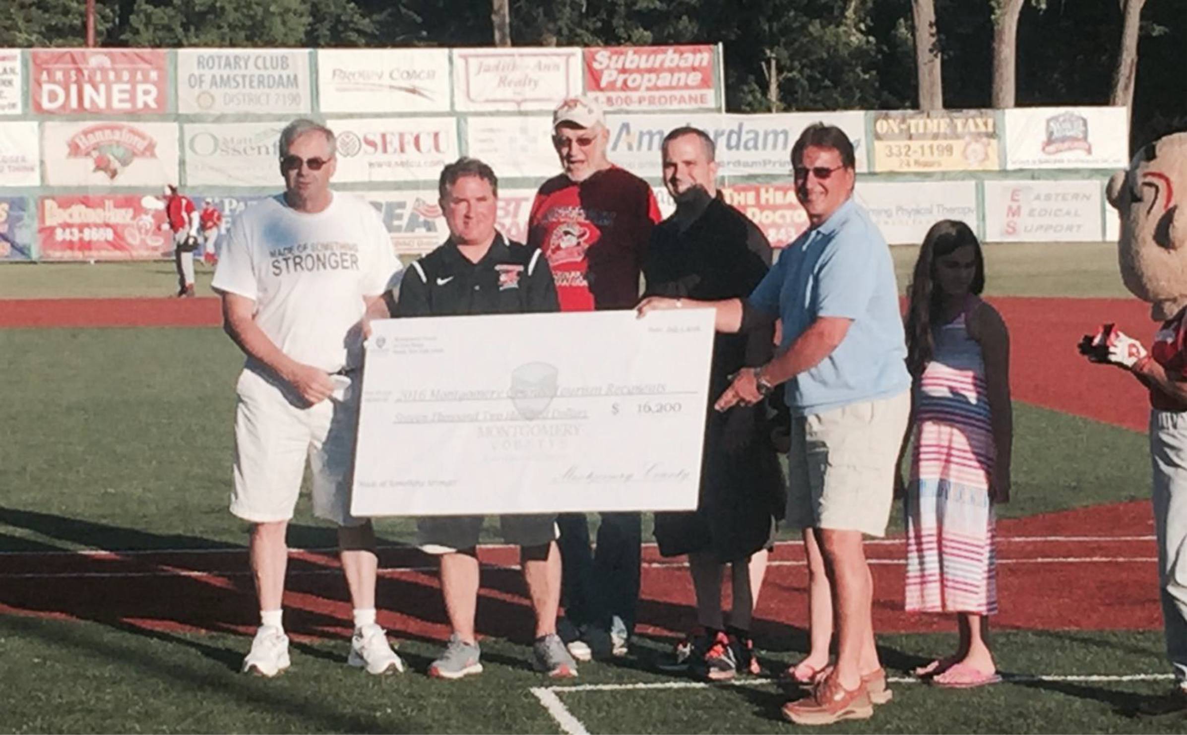 Montgomery Count Legislators gift check for the 2016 Local Tourism Grant Awards to organizations at the Amsterdam Mohawks game on
Sunday, July 3.