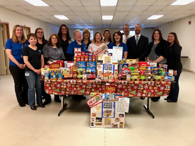 Montgomery County Executive Matthew L. Ossenfort, Fonda-Fultonville District Superintendent Thomas Ciaccio, social worker Melanie Capron, Montgomery County Public and Mental Health Director Sara Boerenko and staff pictured Monday making a donation to Fonda-Fultonville's Backpack Program.