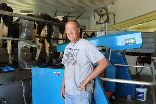 Ray Dykeman in front of his rotary cow parlor at the Dykeman and Sons Inc. farm in Fultonville