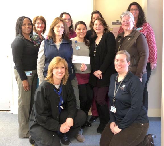 Department of Public/Mental Health Director Sara Boerenko and staff pictured with the check that was donated to the American Heart Association.
