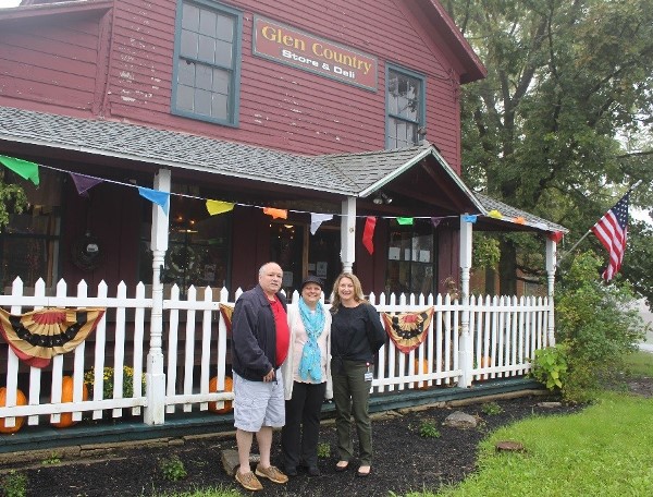 Thomas and Cathy Gatto and Montgomery County Public Health Business Manager Connie Couture pictured in front of the Rustic Red House in the town of Glen.