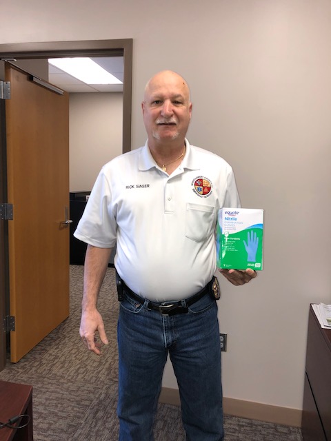 Montgomery County Emergency Management Director Rick Sager pictured with the box of gloves donated from William and Retha Rochelle.