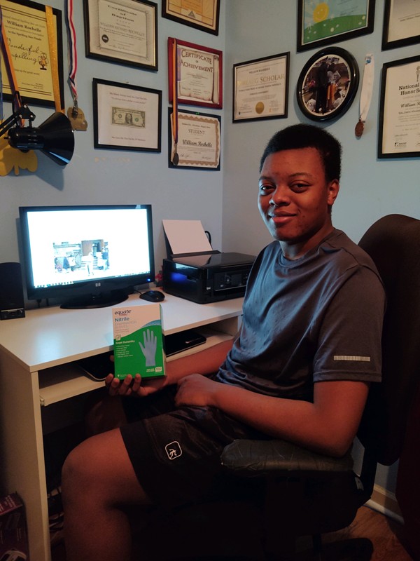 William Rochelle, a 16-year-old from Montgomery, AL, pictured with the box of gloves he mailed to New York to assist healthcare workers during the COVID-19 pandemic.