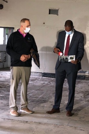 County Executive Matthew L. Ossenfort and U.S. Rep. Antonio Delgado D-19th  look at photos of demolition progress during a tour Tuesday of the Exit 29 Redevelopment Project. 