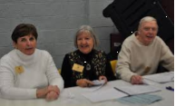 Three election workers seated at a table