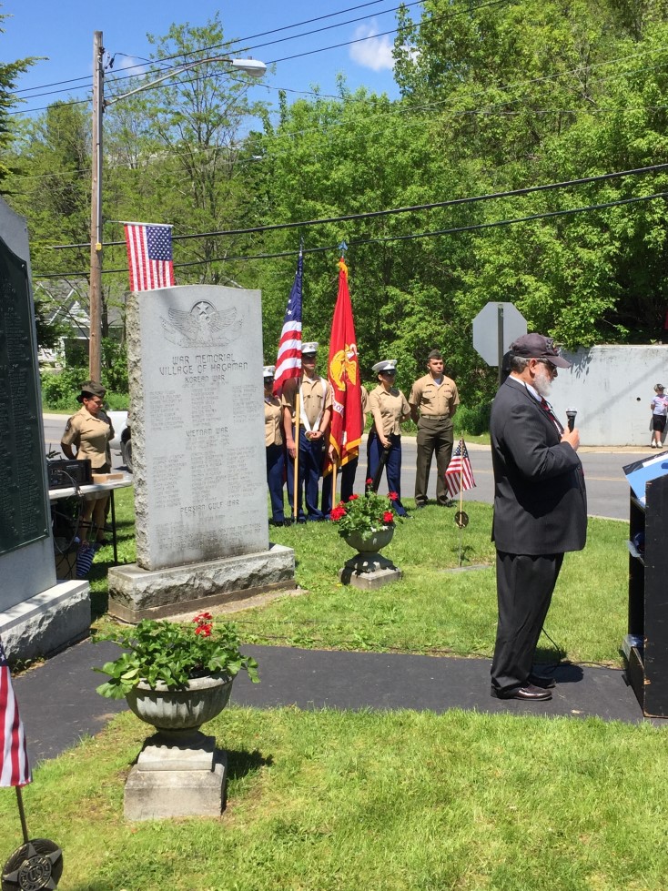 Memorial Day attendees with flags in the background