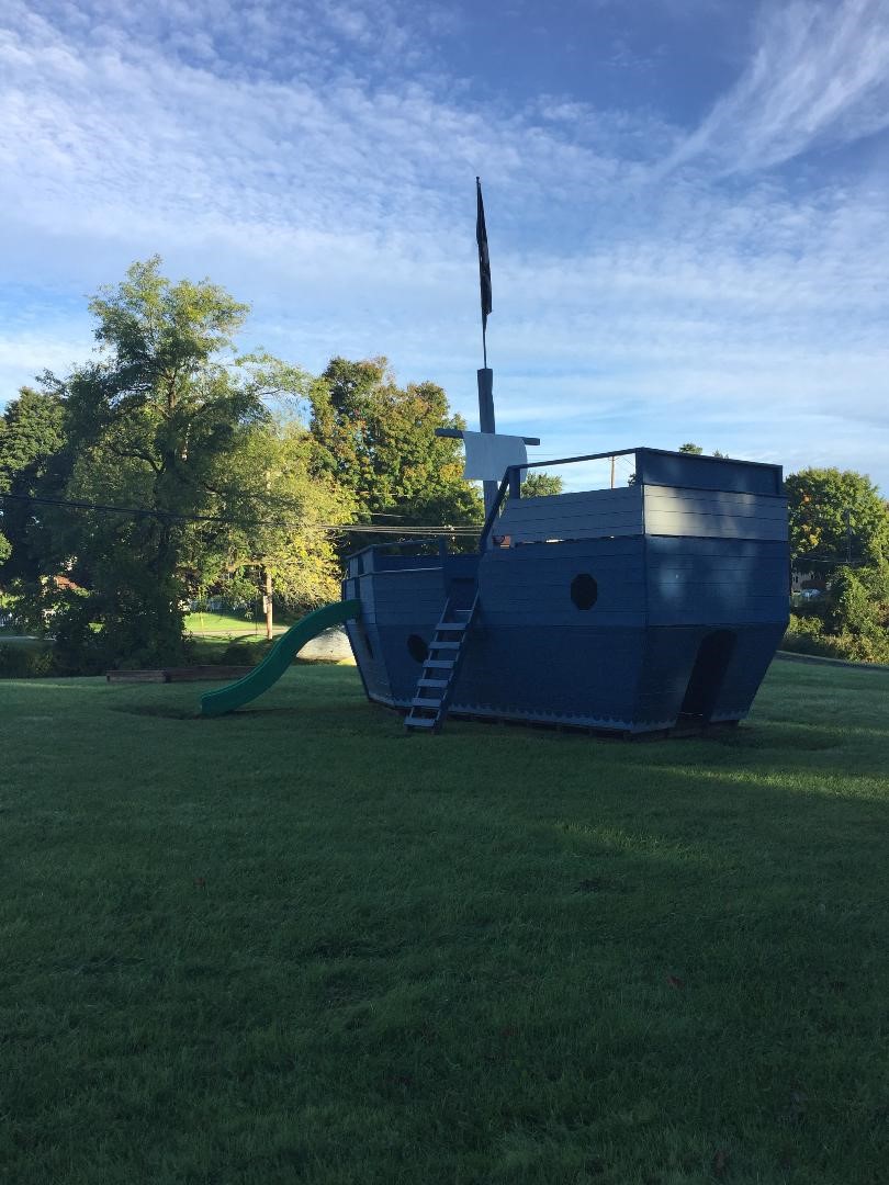 Playground equipment (boat with swing) on a summer day in the park